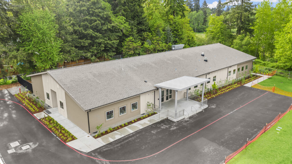 Exterior, aerial view of a custom modular classroom building at an elementary school campus.