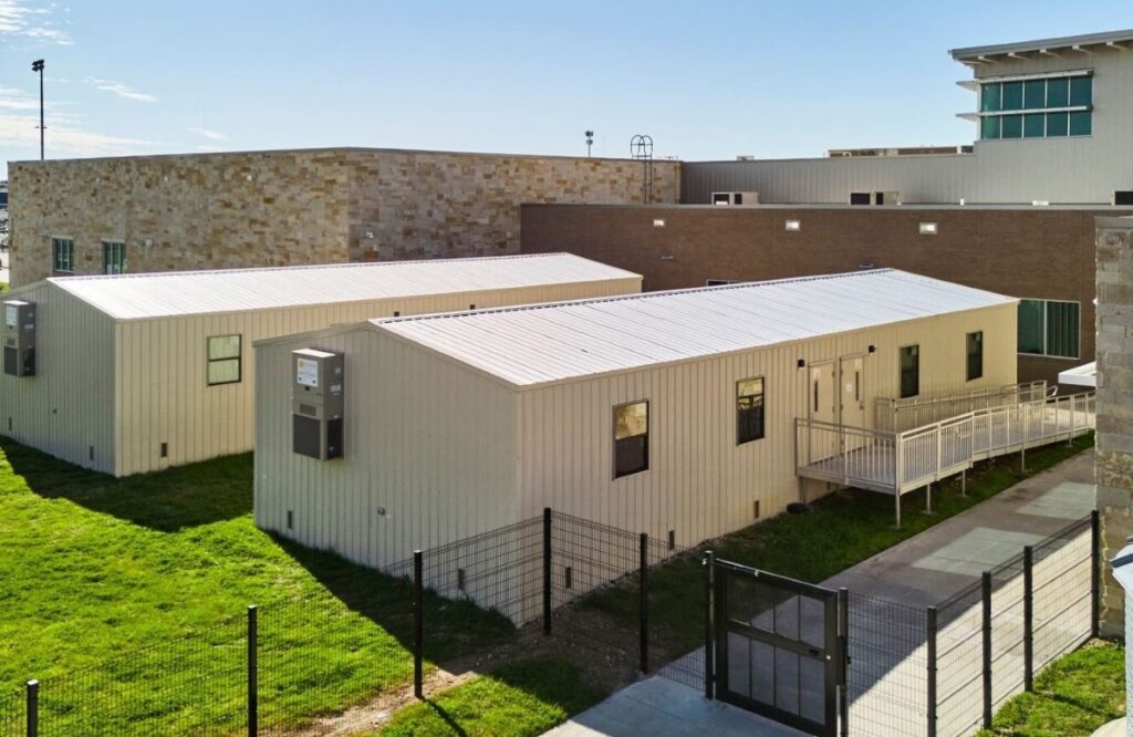 Two modular classroom trailers located on a high school campus.