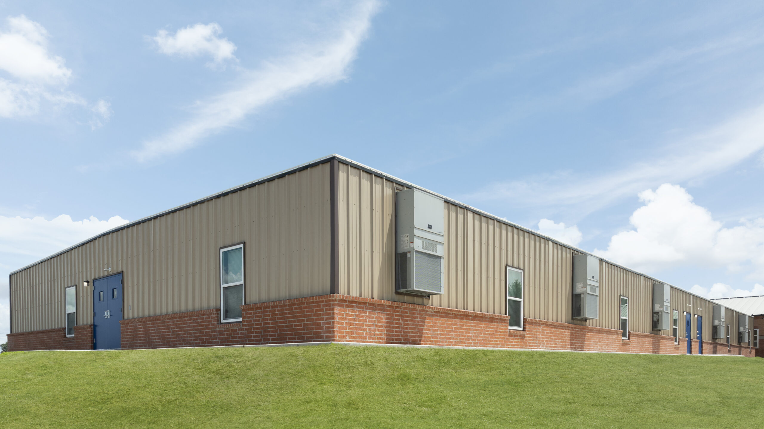 Modular school facility with siding and brick wainscot designed to complement Westhoff ISD