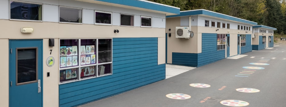 Exterior view of a SAGE modular classroom building, showcasing its modern design and integration